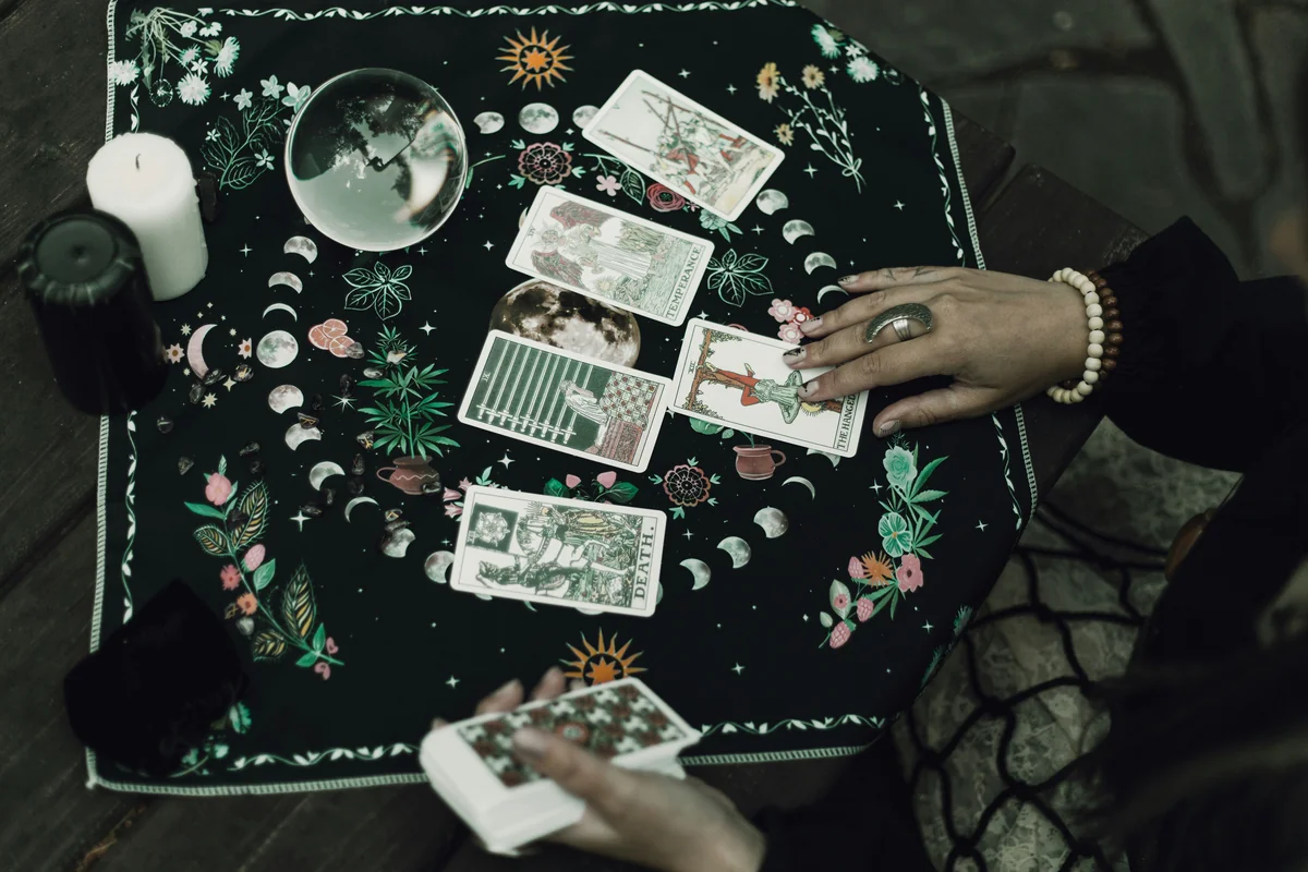 Tarot cards and crystals are used for divination. - affordable psychic phone readings