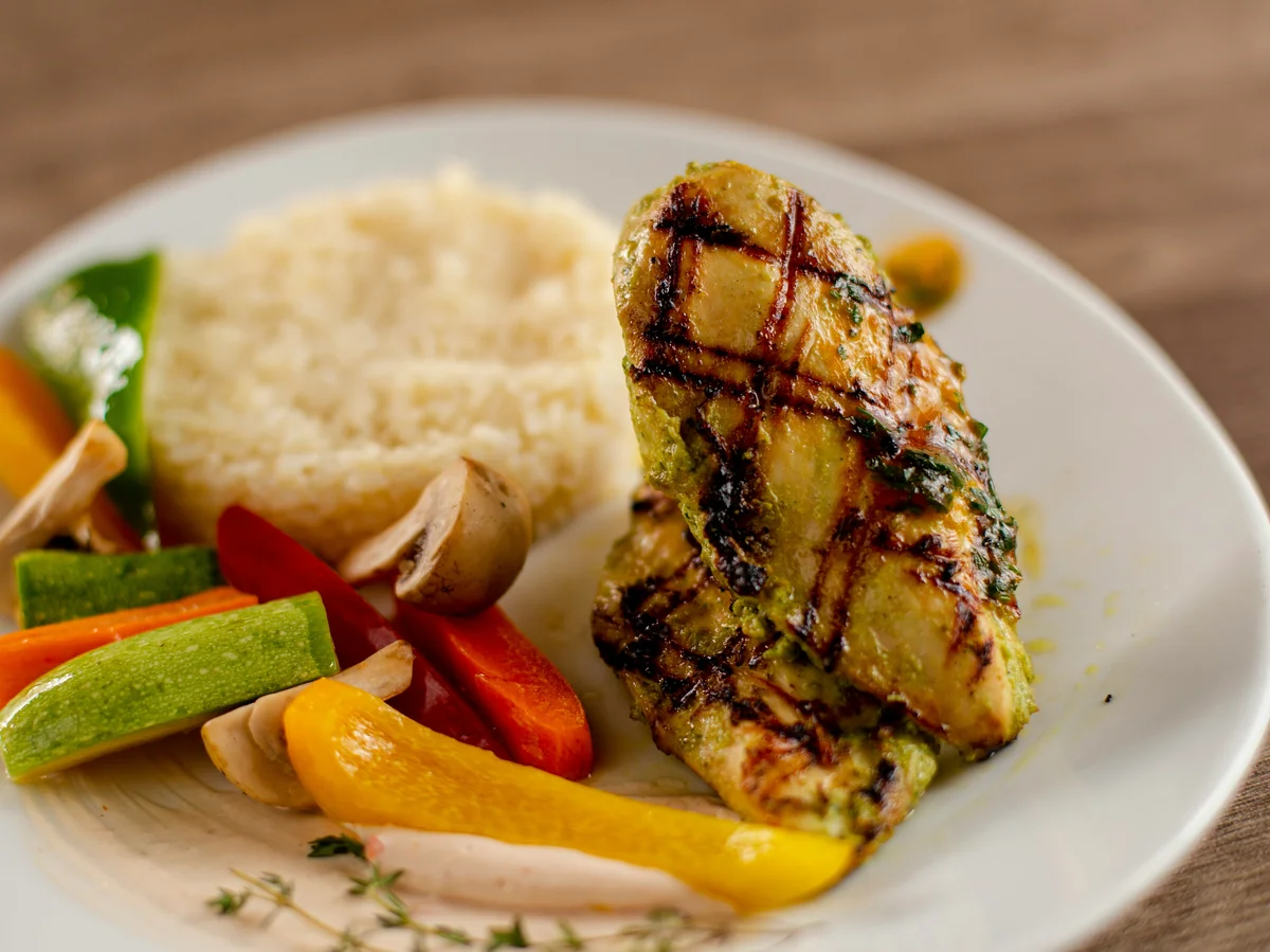 Grilled chicken breast with couscous and colorful vegetables - balanced meals