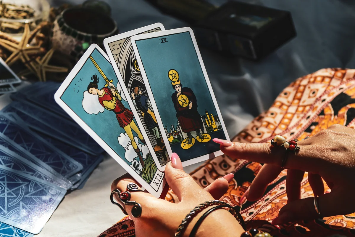 A person holding four cards in their hands - best online psychic readings