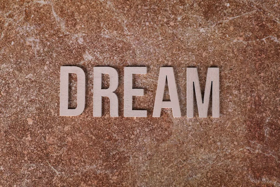 Wooden letters spelling DREAM on textured marble background for motivation. - dream analysis experts online
