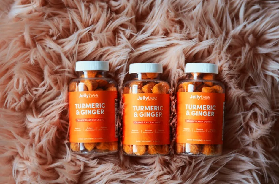 Bottles of orange turmeric and ginger gummies on a plush carpet, promoting health and wellness. - immune support