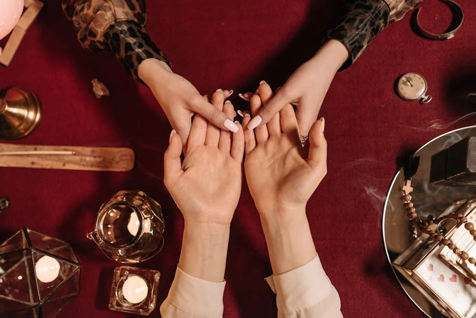 Top-down view of a mystical palm reading session with candles and spiritual objects. - keen vs california psychics
