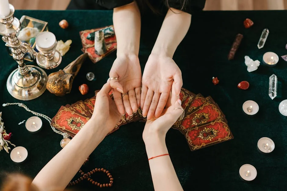 A mystical scene featuring palm reading, tarot cards, candles, and crystals on a dark cloth. - keen vs california psychics
