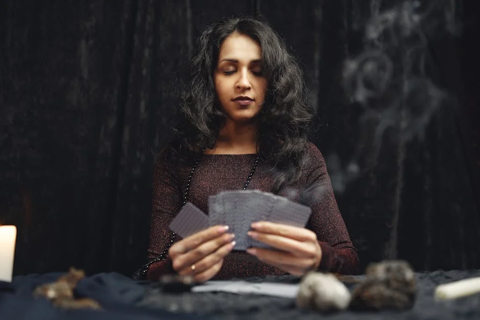 A woman engaging in a spiritual card reading session with candles, smoke, and crystals. - keen psychic reviews