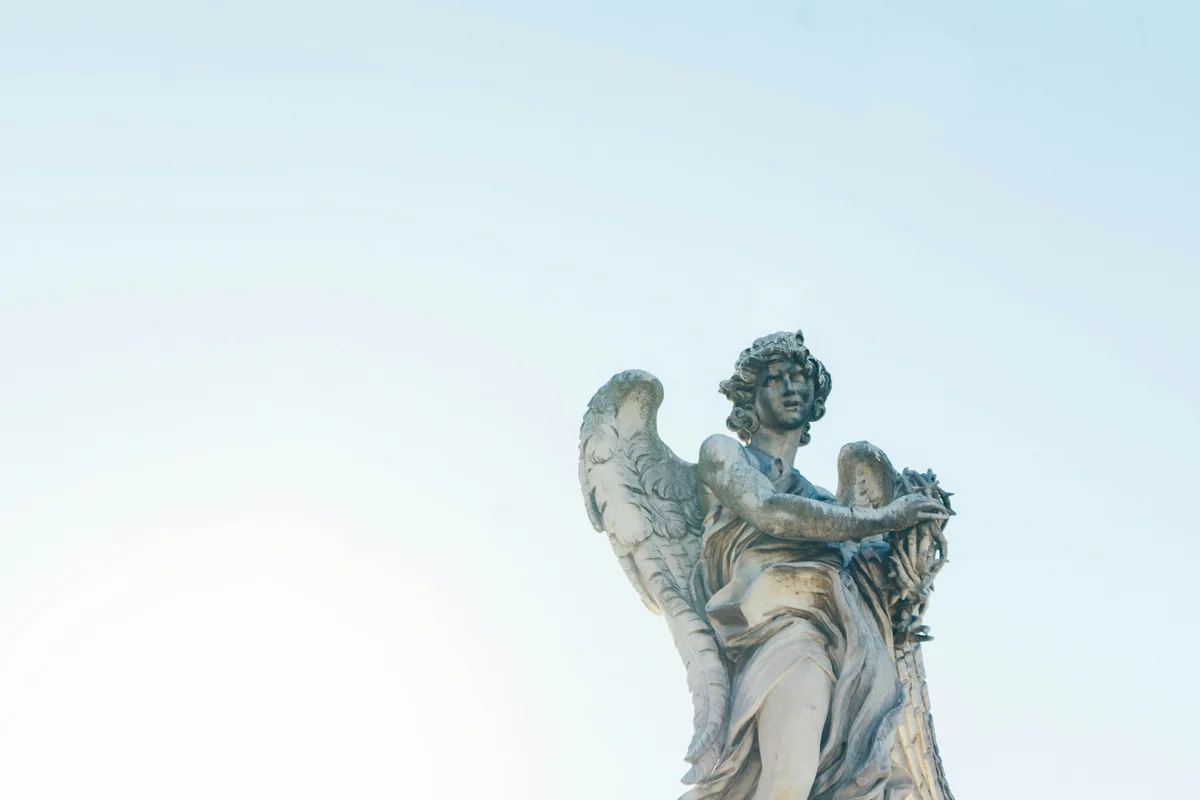 low-angle photography of angel statue - meaning of angel numbers