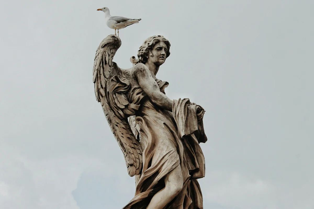 A statue with a bird on top of it - meaning of angel numbers