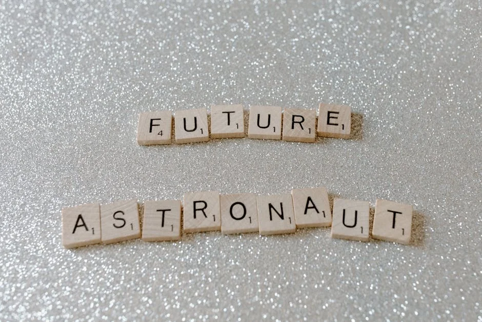 Wooden Scrabble tiles spelling 'Future Astronaut' on a glittery silver background. - mercury retrograde survival tips