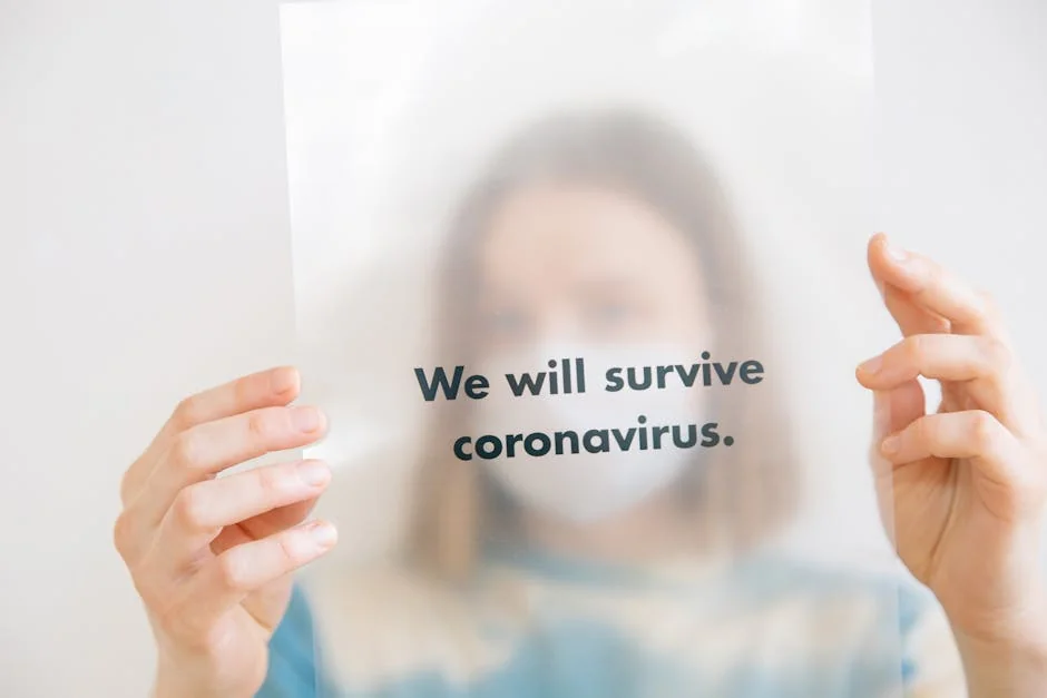 A person holds a sign saying 'We will survive coronavirus,' conveying hope during the pandemic. - mercury retrograde survival tips