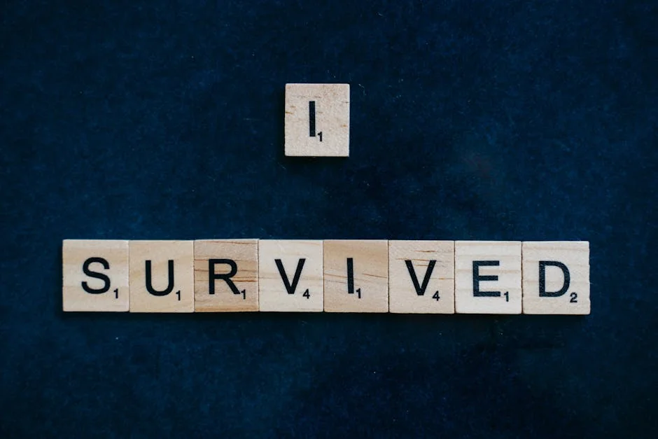 Wooden Scrabble tiles spelling 'I Survived' on a dark surface conveying strength and resilience. - mercury retrograde survival tips