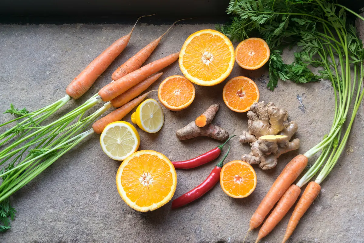 sliced orange fruit beside green and orange vegetable - mindful eating