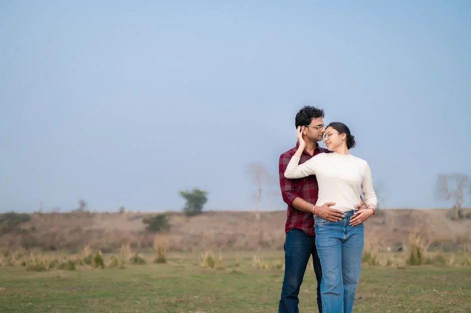 A loving couple embraces in a picturesque outdoor meadow, enjoying a serene moment together. - couple love together - Relationship advice psychics