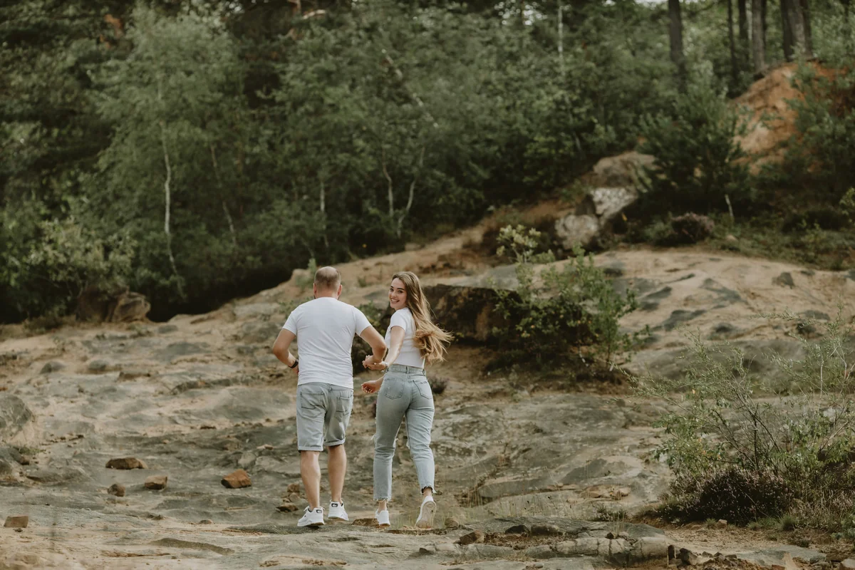 a man and woman walking on a dirt path in the woods - couple love together - Relationship advice psychics