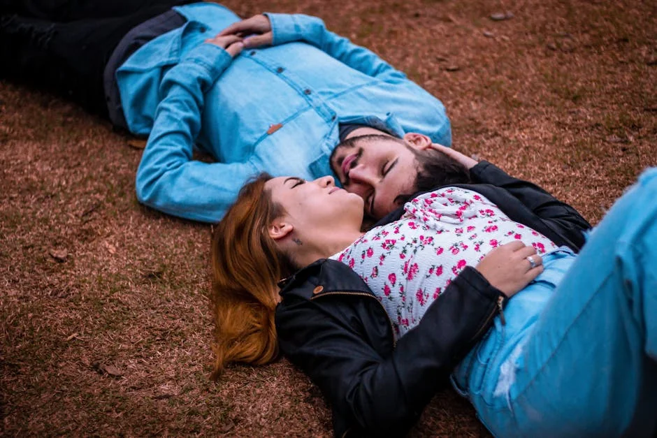 A young couple lying together on grass, enjoying a peaceful moment outdoors. - couple love together - Relationship advice psychics