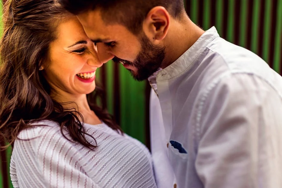 Close-up of a happy couple laughing and embracing outdoors in Toledo, Spain. - couple love together - Relationship advice psychics