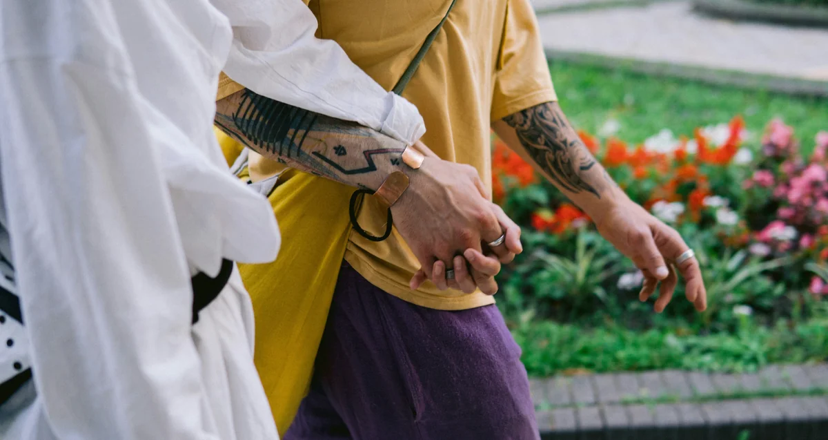 person in white long sleeve shirt holding brown and black fish - couple love together - Relationship advice psychics