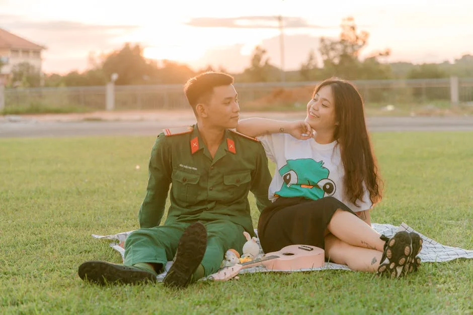 A couple enjoys a romantic moment outdoors at sunset, sitting on grass and connecting together. - couple love together - Relationship advice psychics