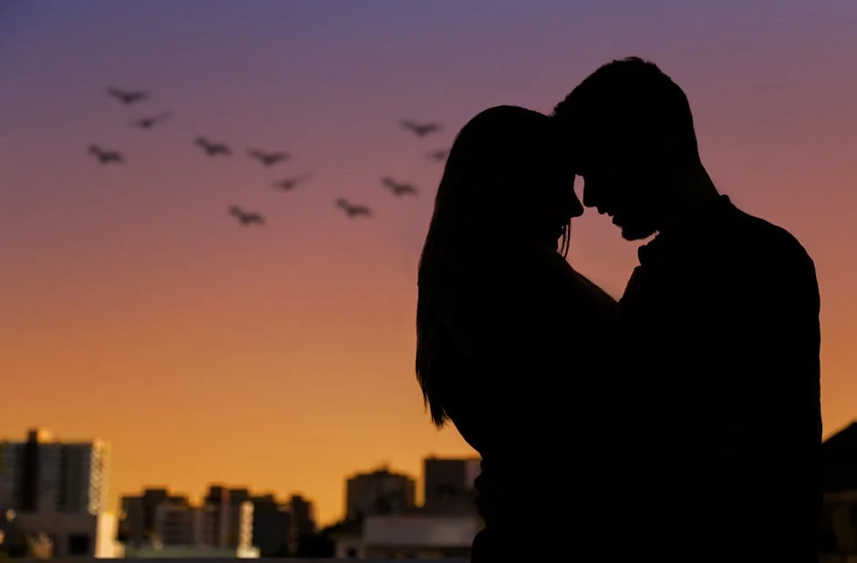 Silhouette of a couple embracing at sunset in an urban setting, evoking romance. - couple love together - Relationship advice psychics