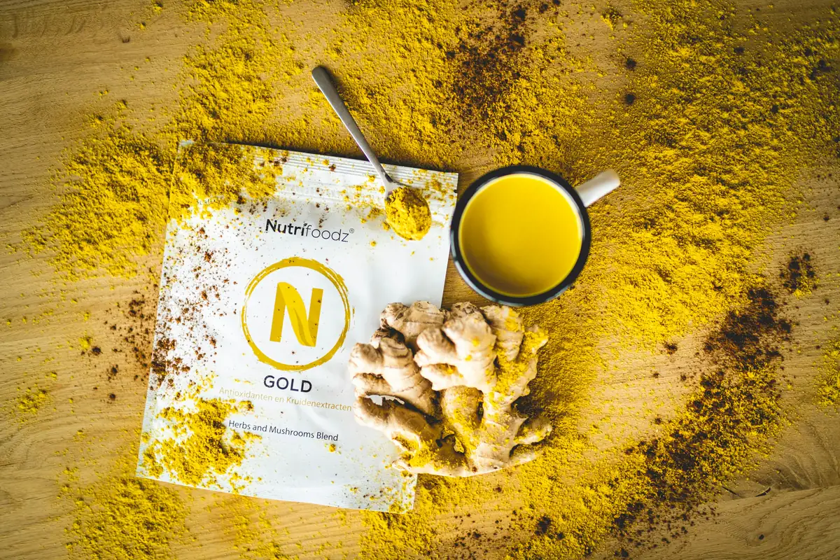a cup of coffee next to a napkin with a yellow substance on it - superfoods