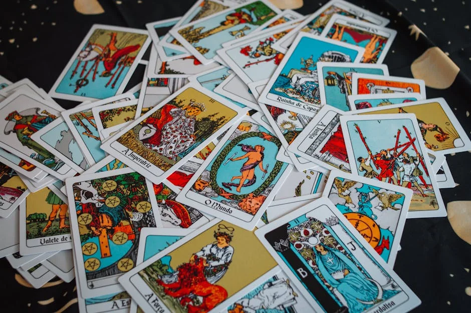 A mixed spread of colorful Tarot cards laid on a starry-patterned fabric. - trusted tarot readers online
