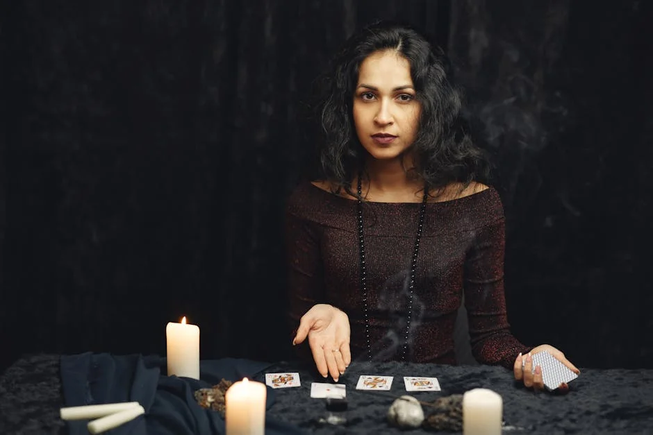 A woman engages in a tarot card reading surrounded by candles, evoking a mystical atmosphere. - trusted tarot readers online