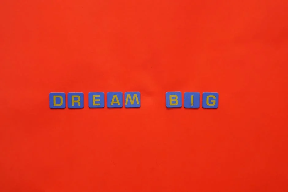 Blue tiles forming the 'Dream Big' quote against a striking red background. - dream analysis experts online