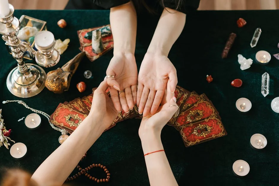 A mystical scene featuring palm reading, tarot cards, candles, and crystals on a dark cloth. - keen vs california psychics